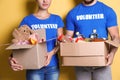 Young volunteers holding boxes with donations