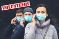 Young volunteers wearing face mask. Coronavirus epidemic. Volunteers with mobile phone. Global pandemic. Coronavirus quarantine