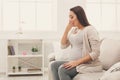 Young vomiting woman sitting on sofa Royalty Free Stock Photo