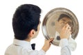 The young waiter with black hair waxes to shine tray for cupboards close-up