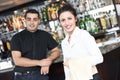 Young waitress at service in restaurant