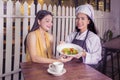 Young waitress serving salad on plate to customer Royalty Free Stock Photo