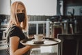 Young waitress standing in cafe. girl the waiter holds in bunches a tray with utensils. Restaurant service Royalty Free Stock Photo