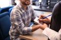 Young waitress taking an order from man in restaurant Royalty Free Stock Photo