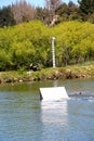 Young wakeboarder going big off a jump at the cable park Royalty Free Stock Photo