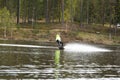 Young wakeboarder rides a wakeboard on the lake. Wakeboarding is cool, extreme sport Royalty Free Stock Photo