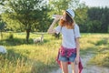 Young walking teen girl drinking water from bottle Royalty Free Stock Photo