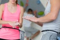 Young wall climbing couple putting chalk on hands