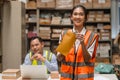 Young warehouse woman worker happy with salary cash bonus money from hard working in inventory industry Royalty Free Stock Photo