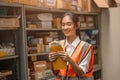 Young warehouse woman worker happy with salary cash bonus money from hard working in inventory industry Royalty Free Stock Photo