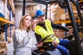 Young warehouse workers working together.