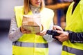 Young warehouse workers working together.