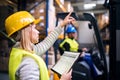 Young warehouse workers working together. Royalty Free Stock Photo