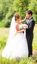 Young wedding couple enjoying romantic moments outside on a summer meadow Royalty Free Stock Photo