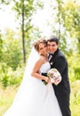 Young wedding couple enjoying romantic moments outside on a summer meadow Royalty Free Stock Photo