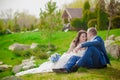 Young wedding couple enjoying romantic moments outside on a summer meadow Royalty Free Stock Photo