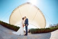 Young wedding couple kissing outdoors