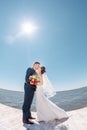 Young Wedding Couple Kissing on Pier Royalty Free Stock Photo