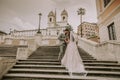 Young wedding couple on Spanish stairs in Rome Royalty Free Stock Photo