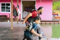 Young wet asian family wearing life jackets getting ready to jump into the lake