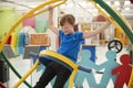 Young white boy in science centre using a human gyroscope Royalty Free Stock Photo
