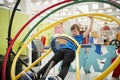 Young white boy in science centre using human gyroscope