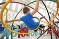Young white boy using a human gyroscope, back view Royalty Free Stock Photo