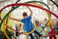 Young white boy using human gyroscope, back view