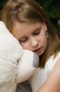 Young girl with a big white teddy bear toy Royalty Free Stock Photo