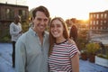 Young white couple embracing at a rooftop party Royalty Free Stock Photo