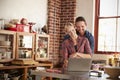 Young white couple using laptop in kitchen embracing Royalty Free Stock Photo
