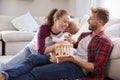 Young white family playing together in sitting room Royalty Free Stock Photo