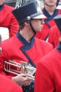 Young white male trumpet player in a marching band in the Cherry Blossom Festival in Macon, GA