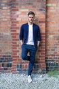 Young white man with a brick wall background