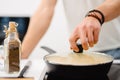 Young white man using frying pan while cooking in kitchen Royalty Free Stock Photo