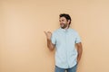 Young white man wearing shirt laughing and pointing finger aside Royalty Free Stock Photo