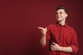 Young white man wearing shirt pointing finger aside and laughing Royalty Free Stock Photo