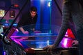 Young white man and woman playing air hockey