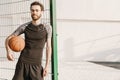 Young white man working out with ball on sports ground Royalty Free Stock Photo