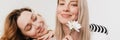 Young white two women hugging and smiling while posing with flowers Royalty Free Stock Photo