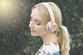 Caucasian Millennial Woman is Inspired by the Music She Hears in Her Headphones Royalty Free Stock Photo