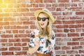 Young White Woman Holds an Ice Cream Cone with Shades and a Fedora in the Summer Royalty Free Stock Photo