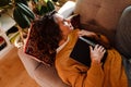 Young white woman reading book while lying on couch Royalty Free Stock Photo