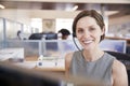 Young white woman working in a call centre smiling to camera Royalty Free Stock Photo