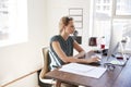 Young white woman working in an office using a computer Royalty Free Stock Photo