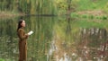 Girl Writes At Autumn Landscape