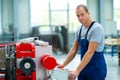 Young white worker in factory using machine Royalty Free Stock Photo