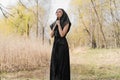 Young widow in a black mourning dress and headscarf suffering, praying and crying with bloody tears. Royalty Free Stock Photo