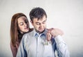 Young wife pulls out dollar bills from her husband`s shirt pocket, the husband grabbed her hand and does not allow to pull out th