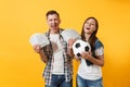 Young win couple, woman man, football fans holding bundle of dollars, cash money, soccer ball, cheer up support team Royalty Free Stock Photo